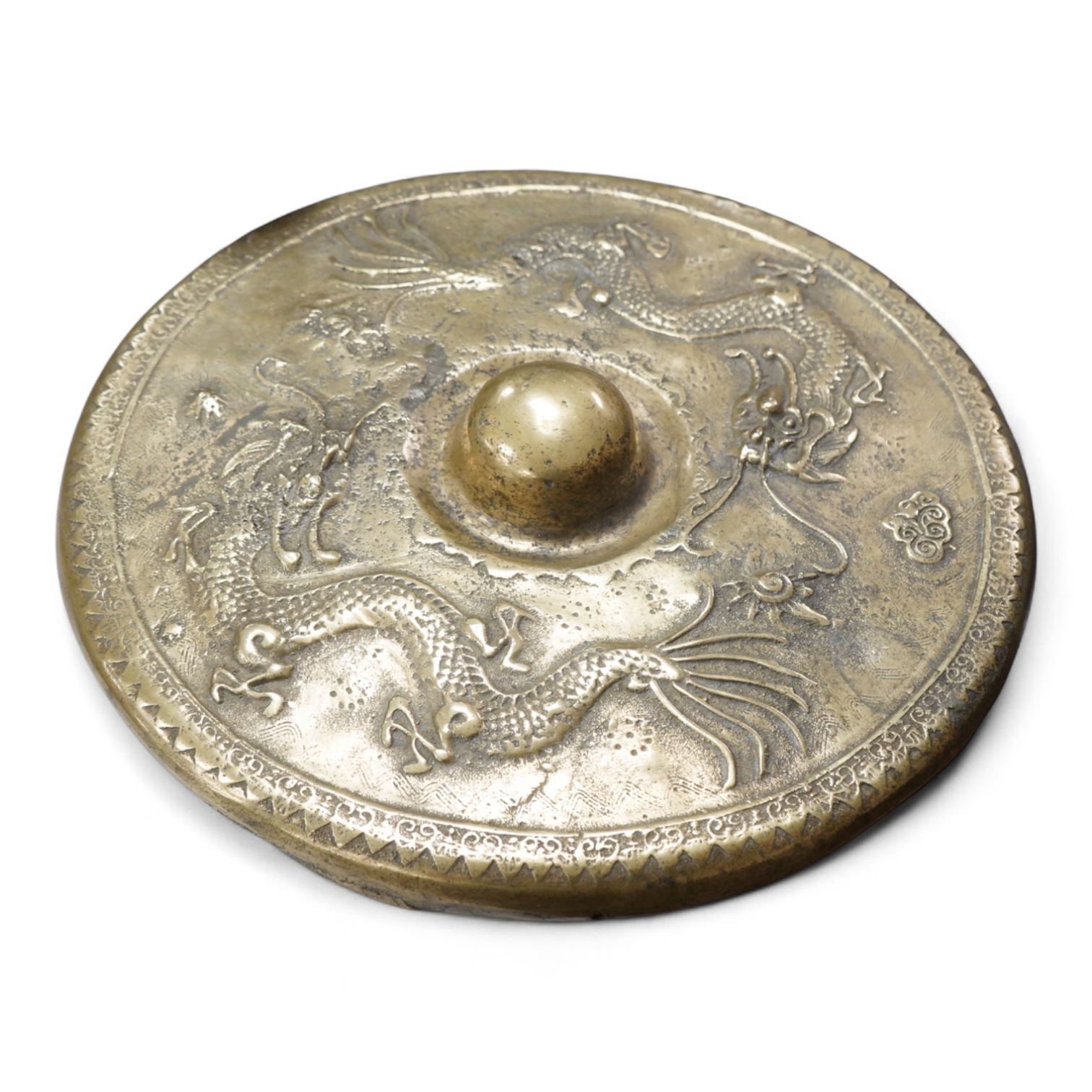 A Brunei bronze temple gong, decorated in relief with a three clawed dragon, 38cm in diameter